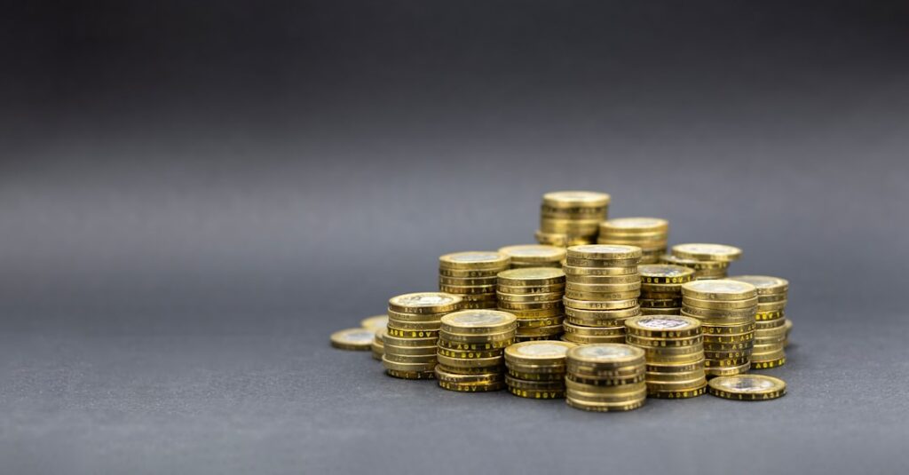 Uma Pilha De Moedas De Ouro Em Um Fundo Escuro cDOebhAKFZY