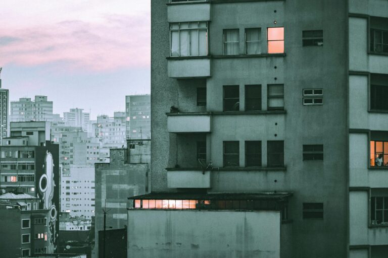 Explore the urban skyline of São Paulo with modern architecture at dusk, featuring illuminated windows and a serene atmosphere.