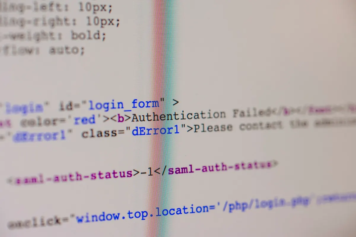 Close-up of HTML and PHP code on screen showing error message and login form data.